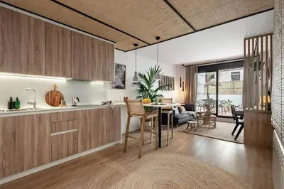 a living room with a television and a table at Bintan - 1 bedroom and terrace in Gràcia in Barcelona