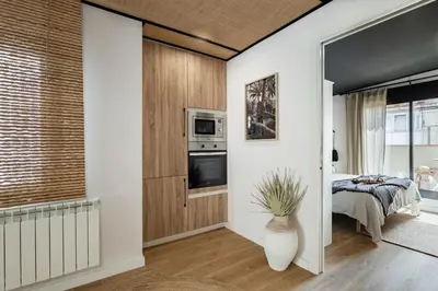 a kitchen and dining room with a table and chairs at Bintan - 1 bedroom and terrace in Gràcia in Barcelona