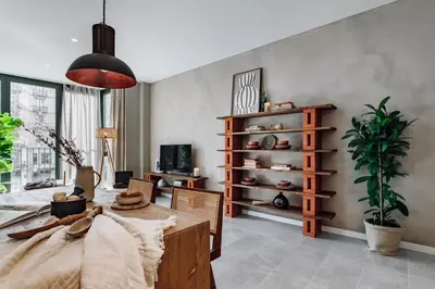 a living room with a table and a potted plant at Encina - 2 bedrooms in Eixample Esquerra in Barcelona