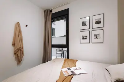 a bedroom with a bed with two books on it at Encina - 2 bedrooms in Eixample Esquerra in Barcelona