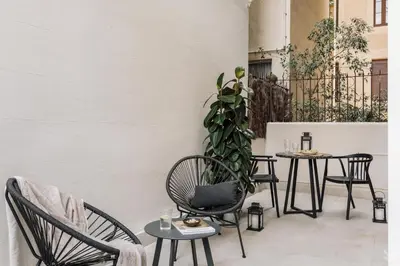 a bedroom with a bed and a desk and a window at Halite - 2 bedrooms, terrace, and balcony in Gràcia in Barcelona