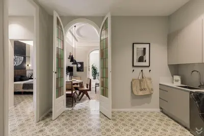a door leading into a dining room with a table at Halite - 2 bedrooms, terrace, and balcony in Gràcia in Barcelona