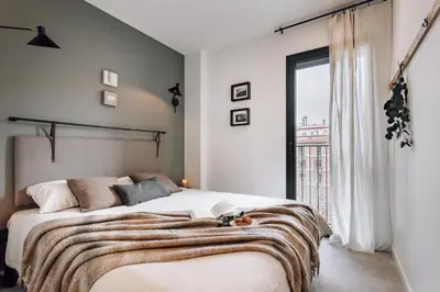 a living room with a table and chairs at Taull - 3 bedrooms in Eixample Esquerra in Barcelona