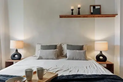 a bedroom with a bed and a mirror at Canet - 1 bedroom in Ciutat Vella in Barcelona