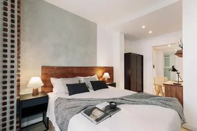 a kitchen and living room with a table and chairs at Ebre - 1 bedroom and balcony in Eixampre Esquerre in Barcelona