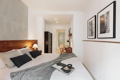 a bedroom with a large white bed with two lamps at Ebre - 1 bedroom and balcony in Eixampre Esquerre in Barcelona