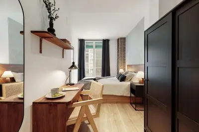 a bedroom with a bed with a book on it at Ebre - 1 bedroom and balcony in Eixampre Esquerre in Barcelona