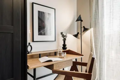 a kitchen with white cabinets and a wooden table and chairs at Roc - 2 bedrooms in Poblenou in Barcelona