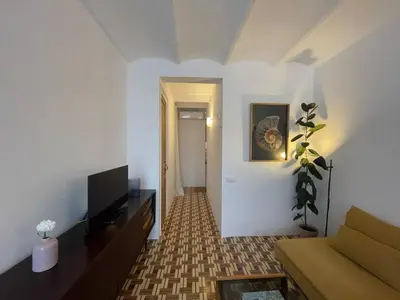a living room with a couch and a television at Barcelona Besos Apartment | 15' to Plaza Cataluña in Sant Adria de Besos