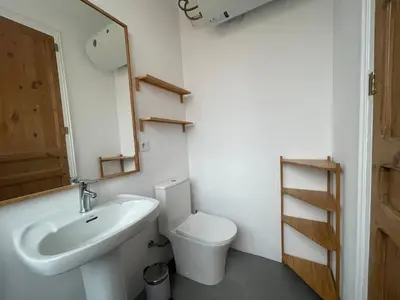 a bathroom with a sink and a toilet and a mirror at Barcelona Besos Apartment | 15' to Plaza Cataluña in Sant Adria de Besos