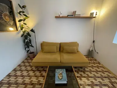 a small room with a couch and a table at Barcelona Besos Apartment | 15' to Plaza Cataluña in Sant Adria de Besos