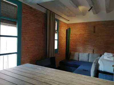 a room with a brick wall and a couch at Barceloneta Mar Street - BM11 in Barcelona