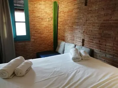 a bedroom with a white bed with towels on it at Barceloneta Mar Street - BM11 in Barcelona