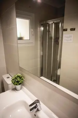 a bathroom with a sink and a mirror and a toilet at Habitación El Patufet en Casa Camí de les Aigües Monistrol de Montserrat in Monistrol