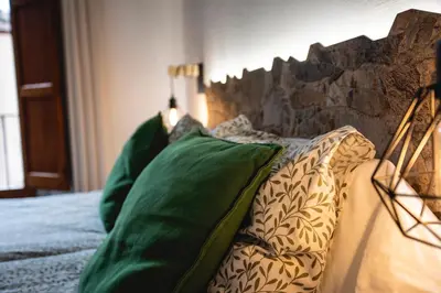 a bedroom with a bed with green pillows on it at Habitación L'Elefant en Casa Camí de les Aigües Monistrol de Montserrat in Monistrol