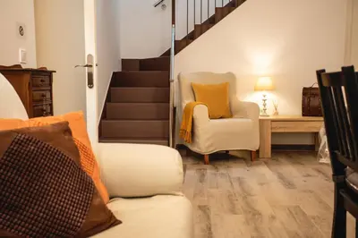 a staircase leading to a dining room with a table at Habitación L'Elefant en Casa Camí de les Aigües Monistrol de Montserrat in Monistrol