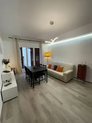 a living room with a couch and a chair and stairs at Habitación Roca Foradada en Casa Camí de les Aigües Monistrol de Montserrat in Monistrol