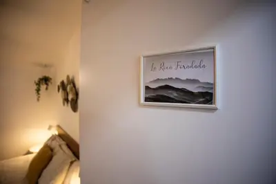 a picture hanging on a wall in a bedroom at Habitación Roca Foradada en Casa Camí de les Aigües Monistrol de Montserrat in Monistrol
