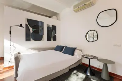 a bedroom with a white bed and two mirrors at Enjoy Apartments Urban Retreat Valencia 3 in Barcelona