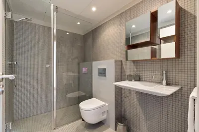 a bathroom with a toilet and a sink and a shower at Enjoy Apartments Urban Retreat Valencia 3 in Barcelona