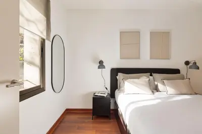 a white bedroom with a bed and a window at Enjoy Apartments Urban Retreat Valencia 3 in Barcelona