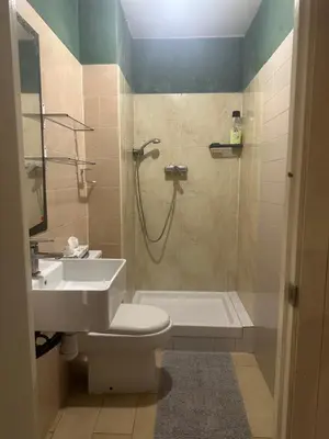a bathroom with a shower and a toilet and a sink at Habitación camp nou in Barcelona