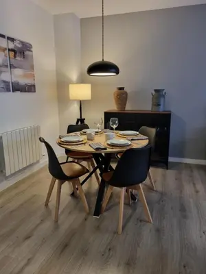 a dining room table with chairs and a lamp at QEhome - confort, parking y cargador EV en el centro de Manresa in Manresa