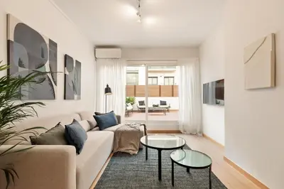 a living room with a couch and two tables at Enjoy Apartments Ecuador in Barcelona