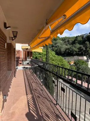 a balcony with yellow umbrellas on a building at Caldetas relax apartment in Sant Vicenç de Montalt