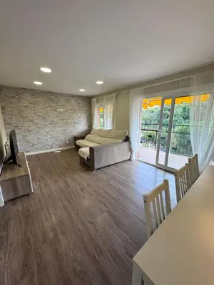 a large room with a bed and a table at Caldetas relax apartment in Sant Vicenç de Montalt