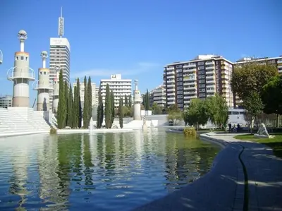 a fountain in the middle of a pond in a city at Apartments BCN Central-Atico Sants in Barcelona