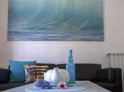 a living room with a couch and a table at Sitges Seafront BATLLÓ in Sitges