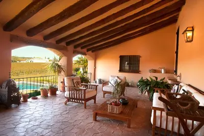 a living room with chairs and a table at Can Julià de Masia Olivera in Subirats
