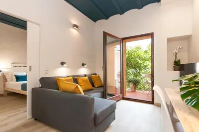 a living room with a couch with yellow pillows at ecoGrusApartments in Masnou