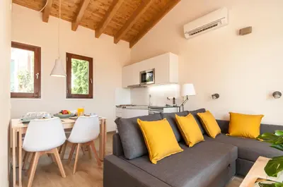 a living room with a gray couch and yellow pillows at ecoGrusApartments in Masnou
