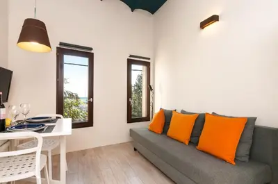 a living room with a couch and a table at ecoGrusApartments in Masnou