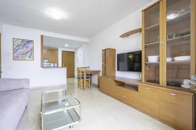 a living room with a couch and a kitchen at HomeHolidaysRentals Belisa - Costa Barcelona in Pineda de Mar