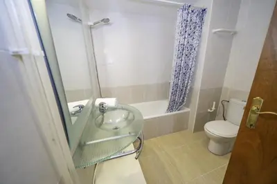 a bathroom with a glass sink and a toilet at HomeHolidaysRentals Belisa - Costa Barcelona in Pineda de Mar