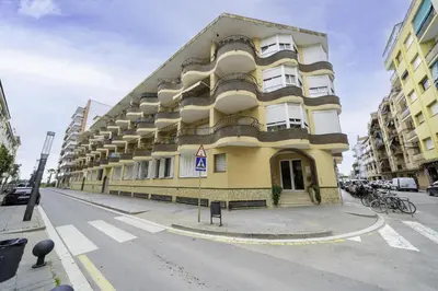 a large yellow building on the side of a street at HomeHolidaysRentals Belisa - Costa Barcelona in Pineda de Mar