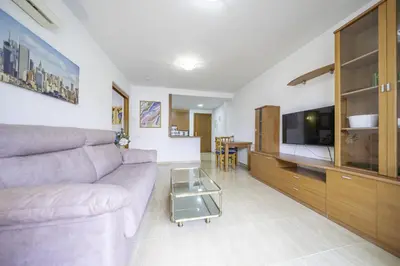 a living room with a couch and a tv at HomeHolidaysRentals Belisa - Costa Barcelona in Pineda de Mar
