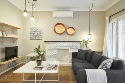a living room with a couch and a fireplace at Spacious 3BRapartment in PobleSec with balcony in Barcelona