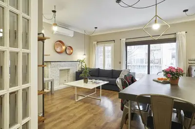 a living room with a couch and a table at Spacious 3BRapartment in PobleSec with balcony in Barcelona
