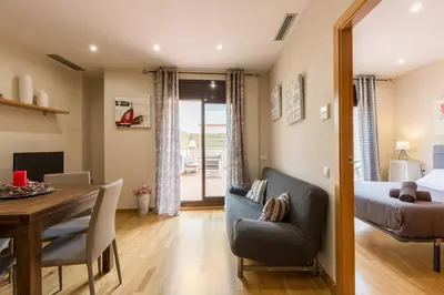 a room with a dining table and a bed and a dining room at Matarolux28 in Mataró