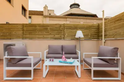 two chairs and a table on a patio at Matarolux28 in Mataró