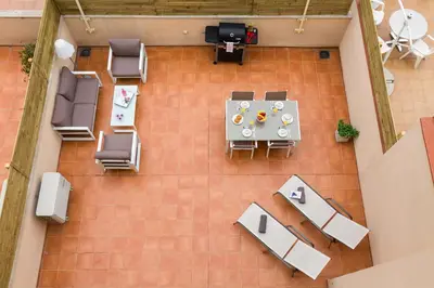 an overhead view of a patio with a table and chairs at Matarolux28 in Mataró