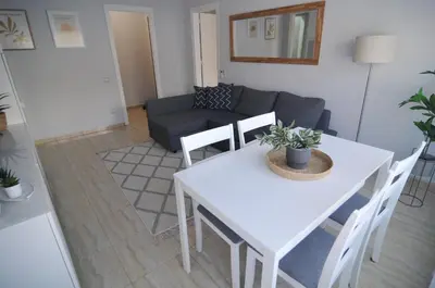 a living room with a white table and a couch at HomeHolidaysRentals Blue - Costa Barcelona in Pineda de Mar
