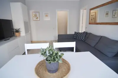 a living room with two tables and a couch at HomeHolidaysRentals Blue - Costa Barcelona in Pineda de Mar