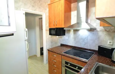 a kitchen with a sink and a stove top oven at HomeHolidaysRentals Blue - Costa Barcelona in Pineda de Mar