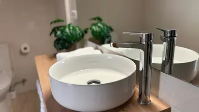 a white sink in a bathroom with a faucet at Dúplex ático familiar by Prestigi in Terrassa