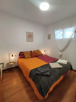 a bedroom with a large bed and a window at Apartamento con vista al mar in Vilanova i la Geltrú